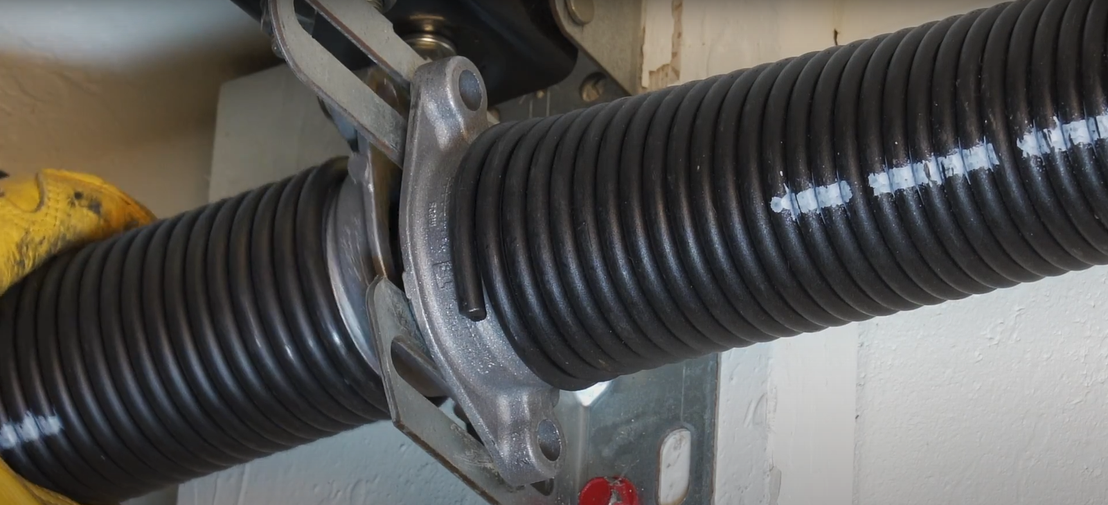 Secure garage door with properly functioning torsion springs maintaining complete closure and structural integrity for home security protection