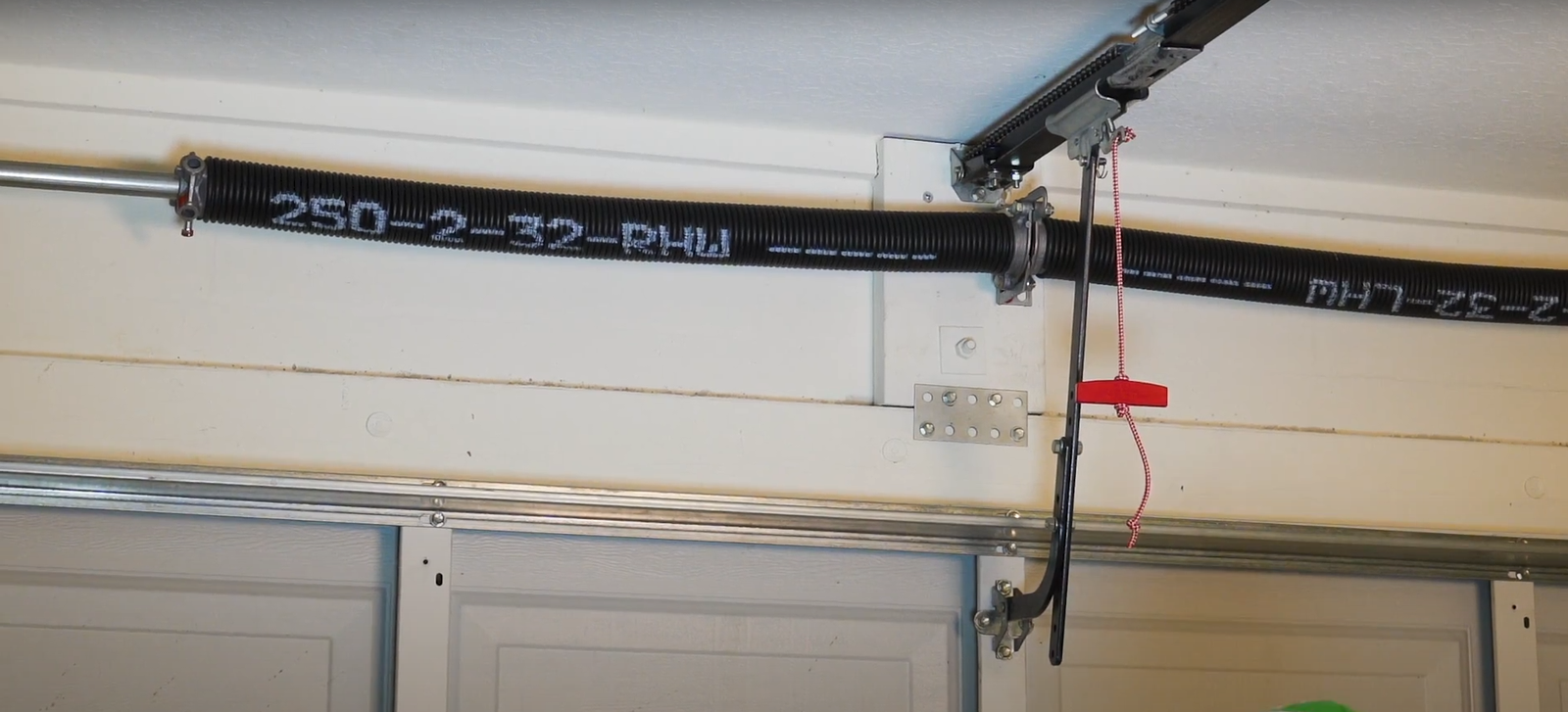 Secure garage door with properly functioning torsion springs maintaining complete closure and structural integrity for home security protection